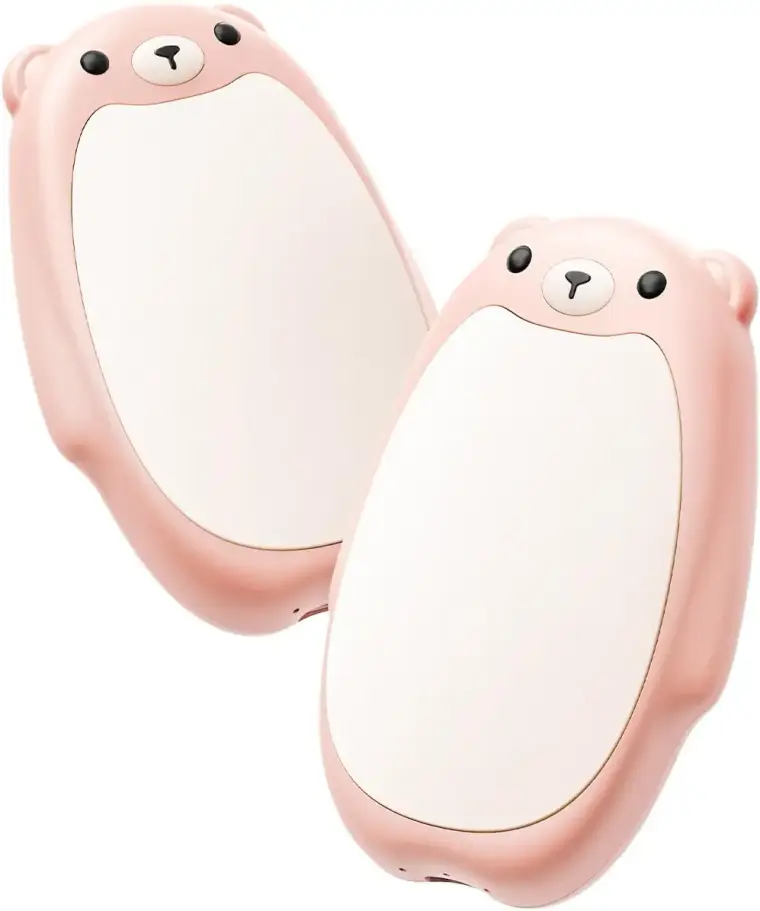 Two cute pink bear slippers with white bellies, black eyes, and tiny noses overlap on a white background, creating a playful, cozy mood.