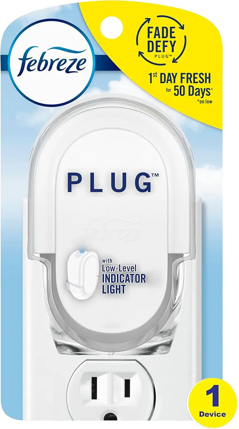 Febreze PLUG air freshener refill device on white packaging, showing low-level indicator light, outlet plug, and “Fade Defy” freshness branding.