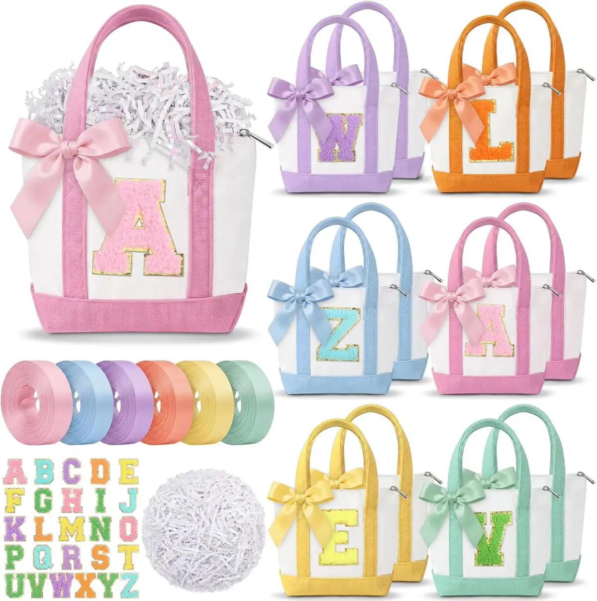 Colorful personalized canvas tote bags with bows and glitter letters, alphabet stickers, pastel ribbons, and shredded paper filler on white.